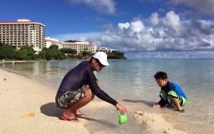 Kenji Kikuchi plays with his son Hideki in Ypao Beach, Tumon, Guam Monday, Aug. 14 2017. (AP Photo/Grace Bordallo)