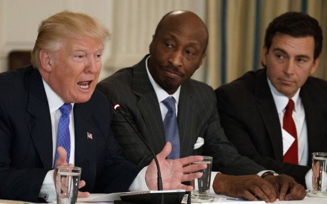 In this Thursday, Feb. 23, 2017, photo, US President Donald Trump, left, speaks during a meeting with manufacturing executives at the White House in Washington, including Merck CEO Kenneth Frazier, center, and Ford CEO Mark Fields. (AP Photo/Evan Vucci) In this Thursday, Feb. 23, 2017, photo, US President Donald Trump, left, speaks during a meeting with manufacturing executives at the White House in Washington, including Merck CEO Kenneth Frazier, center, and Ford CEO Mark Fields. (AP Photo/Evan Vucci)