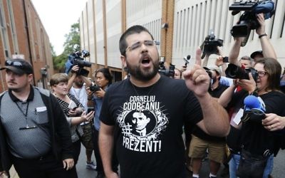 Illustrative: Matthew Heimbach, center, voices his displeasure at the media after a court hearing for James Alex Fields Jr., in front of court in Charlottesville, Virginia, August 14, 2017. (AP/Steve Helber)