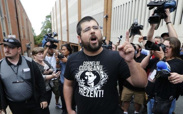 Illustrative: Matthew Heimbach, center, voices his displeasure at the media after a court hearing for James Alex Fields Jr., in front of court in Charlottesville, Virginia, August 14, 2017. (AP/Steve Helber) Illustrative: Matthew Heimbach, center, voices his displeasure at the media after a court hearing for James Alex Fields Jr., in front of court in Charlottesville, Virginia, August 14, 2017. (AP/Steve Helber)