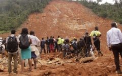 Volunteers wait at the scene of heavy flooding and mudslides in Regent, just outside of Sierra Leone's capital Freetown, Tuesday, Aug. 15 , 2017. (AP Photo/ Kabba Kargbo)