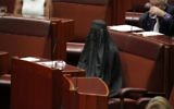 Senator Pauline Hanson wears a burqa during question time in the Senate chamber at Parliament House in Canberra, Australia, Thursday, Aug. 17, 2017. (Jed Cooper/Australian Broadcasting Corp. via AP)