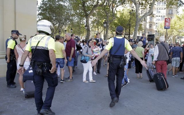 Police officers tell members of the public to leave the scene of a terror attack in a street in Barcelona, Spain, Thursday, Aug. 17, 2017. (AP Photo/Manu Fernandez) Police officers tell members of the public to leave the scene of a terror attack in a street in Barcelona, Spain, Thursday, Aug. 17, 2017. (AP Photo/Manu Fernandez)
