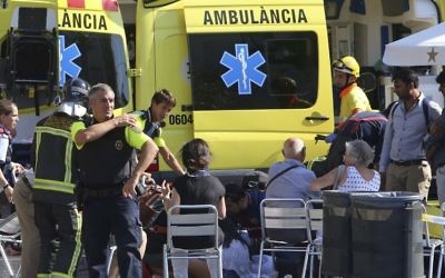 Injured people are treated after a van jumped the sidewalk of the Las Ramblas Boulevard in Barcelona, Spain, on Thursday, August 17, 2017. (AP/Oriol Duran)