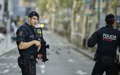 Armed police officers patrol a deserted street in Las Ramblas, in Barcelona, Spain, Friday, August 18, 2017. (AP/Manu Fernandez)