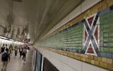 A mosaic tile design meant to represent Times Square's status as the "Crossroads of the World" is part of the subway station's border, in New York, Friday, Aug. 18, 2017. Transit officials have decided to alter subway tiles at the station that have a design that's been compared to the Confederate flag, to make it "crystal clear" that they don't depict the flag. (AP Photo/Richard Drew)