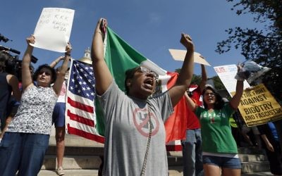 Counterprotesters hold signs and chant at the Statehouse before a planned "Free Speech" rally by conservative organizers begin on the adjacent Boston Common, Saturday, Aug. 19, 2017, in Boston. (AP Photo/Michael Dwyer)