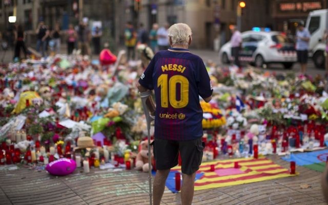 A man stands next to flags, flowers, messages and candles to the victims on Barcelona's historic Las Ramblas promenade. (AP /Emilio Morenatti) A man stands next to flags, flowers, messages and candles to the victims on Barcelona's historic Las Ramblas promenade. (AP /Emilio Morenatti)