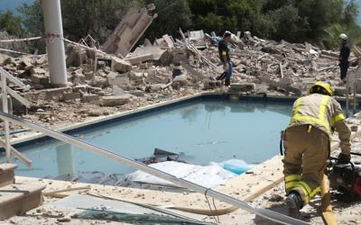 In this photo taken on Friday, Aug. 18, 2017, a motorcycle and a car are loaded on a truck after being removed from the explosion site in Alcanar, Tarragona province, Spain. (AP Photo/Joan Revillas)