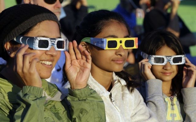 Schweta Kulkarni, from left, Rhea Kulkarni and Saanvi Kulkarni, from Seattle, try out their eclipse glasses on the sun at a gathering of eclipse viewers in Salem, Ore., early Monday, Aug. 21, 2017. (AP/Don Ryan) Schweta Kulkarni, from left, Rhea Kulkarni and Saanvi Kulkarni, from Seattle, try out their eclipse glasses on the sun at a gathering of eclipse viewers in Salem, Ore., early Monday, Aug. 21, 2017. (AP/Don Ryan)