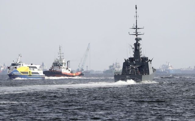The Republic of Singapore Navy's RSS Brave, right, sails off from the Tuas naval base on a search and rescue mission for the USS John S. McCain's missing sailors on Thursday, Aug. 24, 2017, in Singapore. (AP Photo/Wong Maye-E)