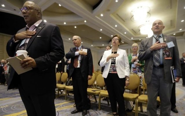People stand for the Pledge of Allegiance during a meeting of the standing committee on rules at the Republican National Committee summer meeting, Thursday, Aug. 24, 2017, in Nashville, Tenn. (Mark Humphrey/AP)