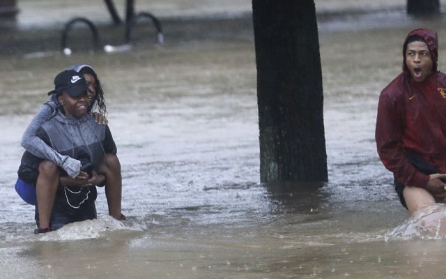 Residents wade through floodwaters from Tropical Storm Harvey, August 27, 2017, in Houston, Texas. (AP Photo/David J. Phillip) Residents wade through floodwaters from Tropical Storm Harvey, August 27, 2017, in Houston, Texas. (AP Photo/David J. Phillip)