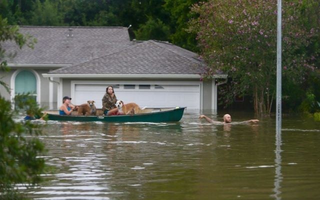A family evacuates their Meyerland home in Houston, August 27, 2017. (Mark Mulligan/Houston Chronicle via AP) A family evacuates their Meyerland home in Houston, August 27, 2017. (Mark Mulligan/Houston Chronicle via AP)