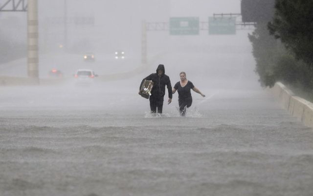 Two people walk down a flooded section of Interstate 610 in floodwaters from Tropical Storm Harvey, August 27, 2017, in Houston, Texas. (AP Photo/David J. Phillip) Two people walk down a flooded section of Interstate 610 in floodwaters from Tropical Storm Harvey, August 27, 2017, in Houston, Texas. (AP Photo/David J. Phillip)