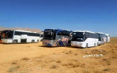 This photo provided on Monday, Aug 28, 2017 by the government-controlled Syrian Central Military Media, shows buses gathering before a planned evacuation of Islamic State group militants, in the mountainous region of Qalamoun, Syria. (Syrian Central Military Media, via AP)