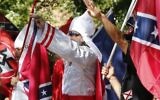 Illustrative: Klan members salute during a KKK rally in Justice Park Saturday, on July 8, 2017, in Charlottesville, Virginia. (AP Photo/Steve Helber)