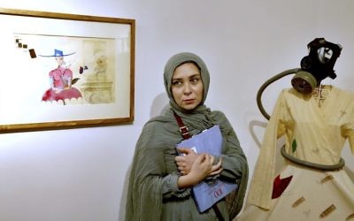 Narges Mousavi, an Iranian artist and daughter of Mir Hossein Mousavi, stands during her exhibition in 'House of Free Designers' art gallery in Tehran, Iran, Friday, Aug. 11, 2017. (Ebrahim Noroozi/AP)