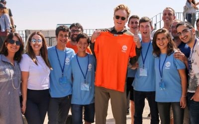 Conan O'Brien, with the Orange T-shirt, meets participants of the Tower of David Museum Hackathon in Jerusalem, Aug. 28, 2017; Elat Lieber, director of the Tower of David Museum, is at the far left (Courtesy: Ricky Rachman)