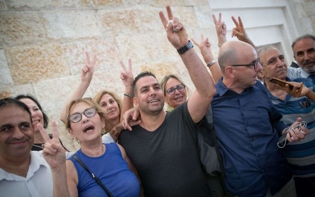 Menny Naftali (C), the former housekeeper of Prime Minister's Residence, and Israeli activist Eldad Yaniv (2R) outside the courtroom of the High Court in Jerusalem, August 24, 2017. (Yonatan Sindel/Flash90) Menny Naftali (C), the former housekeeper of Prime Minister's Residence, and Israeli activist Eldad Yaniv (2R) outside the courtroom of the High Court in Jerusalem, August 24, 2017. (Yonatan Sindel/Flash90)