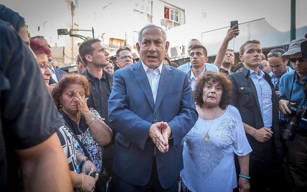 Prime Minister Benjamin Netanyahu meets with residents of south Tel Aviv during a tour in the neighborhood, August 31, 2017. (Miriam Alster/Flash90)
