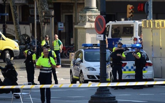 Medical staff members and policemen standing in a cordoned-off area after a van plowed into the crowd on the Las Ramblas Boulevard in Barcelona, Spain, on August 17, 2017. (Josep Lago/AFP/Getty Images) Medical staff members and policemen standing in a cordoned-off area after a van plowed into the crowd on the Las Ramblas Boulevard in Barcelona, Spain, on August 17, 2017. (Josep Lago/AFP/Getty Images)