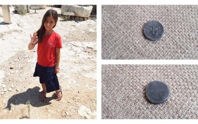 8-year-old Hallel Halevy holding her find of a rare 2,00-year-old half-shekel coin on August 23, 2017 in Halamish. (courtesy)
