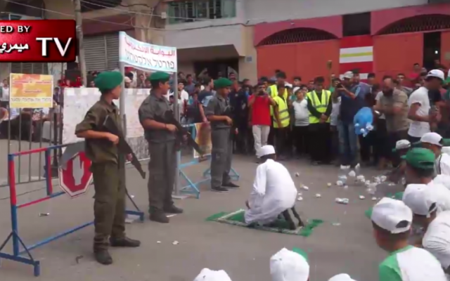 Children take part in a reenactment of the Temple Mount crisis during a Hamas summer camp in the Gaza Strip in July 2017. (Screen capture: MEMRI) Children take part in a reenactment of the Temple Mount crisis during a Hamas summer camp in the Gaza Strip in July 2017. (Screen capture: MEMRI)