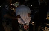 Police detain a man, suspected of instigating riots in East Jerusalem, during arrests carried out overnight August 2, 2017. (Israel Police)