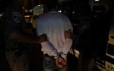 Police detain a man, suspected of instigating riots in East Jerusalem, during arrests carried out overnight August 2, 2017. (Israel Police)