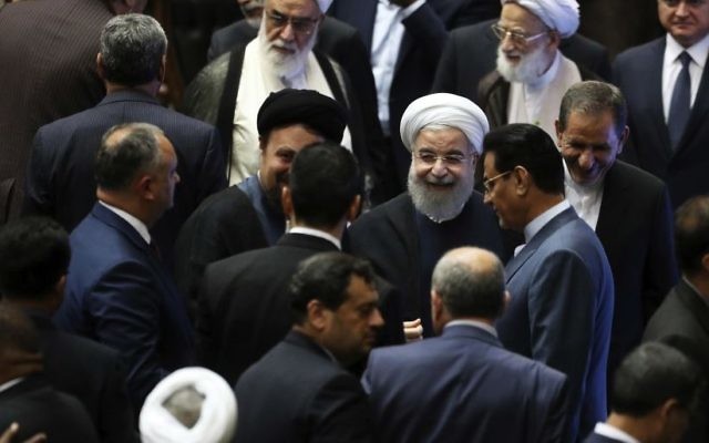 Iran's President Hasan Rouhani, center, leaves the parliament at the end of his swearing-in ceremony for the second term in office, in Tehran, Iran, Saturday, Aug. 5, 2017. (AP Photo/Ebrahim Noroozi) Iran's President Hasan Rouhani, center, leaves the parliament at the end of his swearing-in ceremony for the second term in office, in Tehran, Iran, Saturday, Aug. 5, 2017. (AP Photo/Ebrahim Noroozi)
