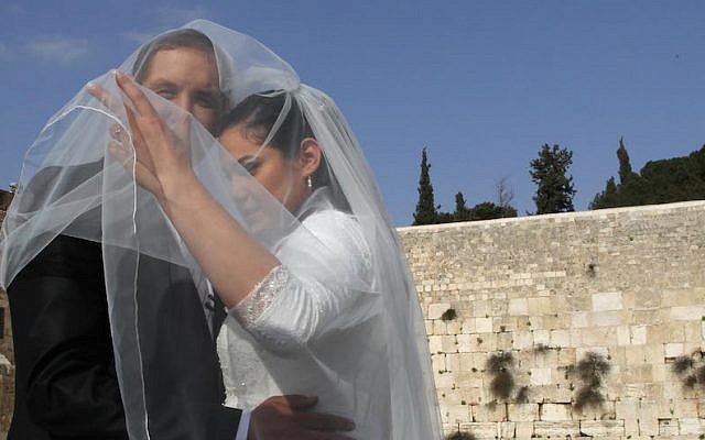 Bride and groom take wedding pictures at the Western Wall in Judaism's Old City. April 13, 2011. (Nati Shohat/Flash90) Bride and groom take wedding pictures at the Western Wall in Judaism's Old City. April 13, 2011. (Nati Shohat/Flash90)