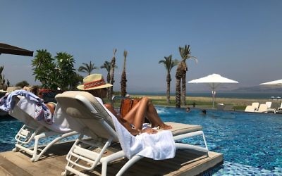A woman sunbathing at the Setai hotel on the shore of the Sea of Galilee in Israel, August 25, 2017. (Andrew Tobin)