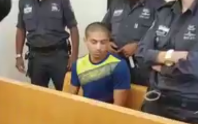 Murder suspect Tamer Hujirat is seen at the Haifa District Court on August 1, 2017. (Screen capture: Twitter) Murder suspect Tamer Hujirat is seen at the Haifa District Court on August 1, 2017. (Screen capture: Twitter)