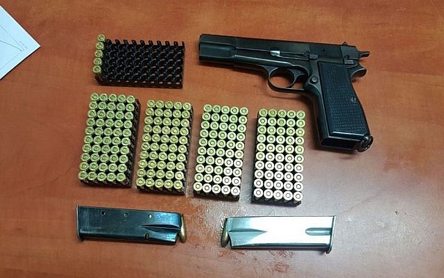 Pistol, magazines and over 200 rounds of ammunition seized in a raid of a family home in the West Bank city of Hebron on August 2, 2017. (Israel Police) Pistol, magazines and over 200 rounds of ammunition seized in a raid of a family home in the West Bank city of Hebron on August 2, 2017. (Israel Police)
