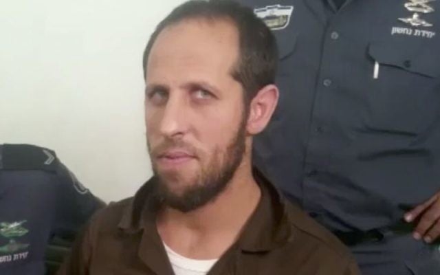 Amjad Jabarin arrives in a Haifa District Court on August 24, 2017, where he is charged with accessory to murder in connection with a terror attack on the Temple Mount in July. (Screen capture: Channel 10) Amjad Jabarin arrives in a Haifa District Court on August 24, 2017, where he is charged with accessory to murder in connection with a terror attack on the Temple Mount in July. (Screen capture: Channel 10)