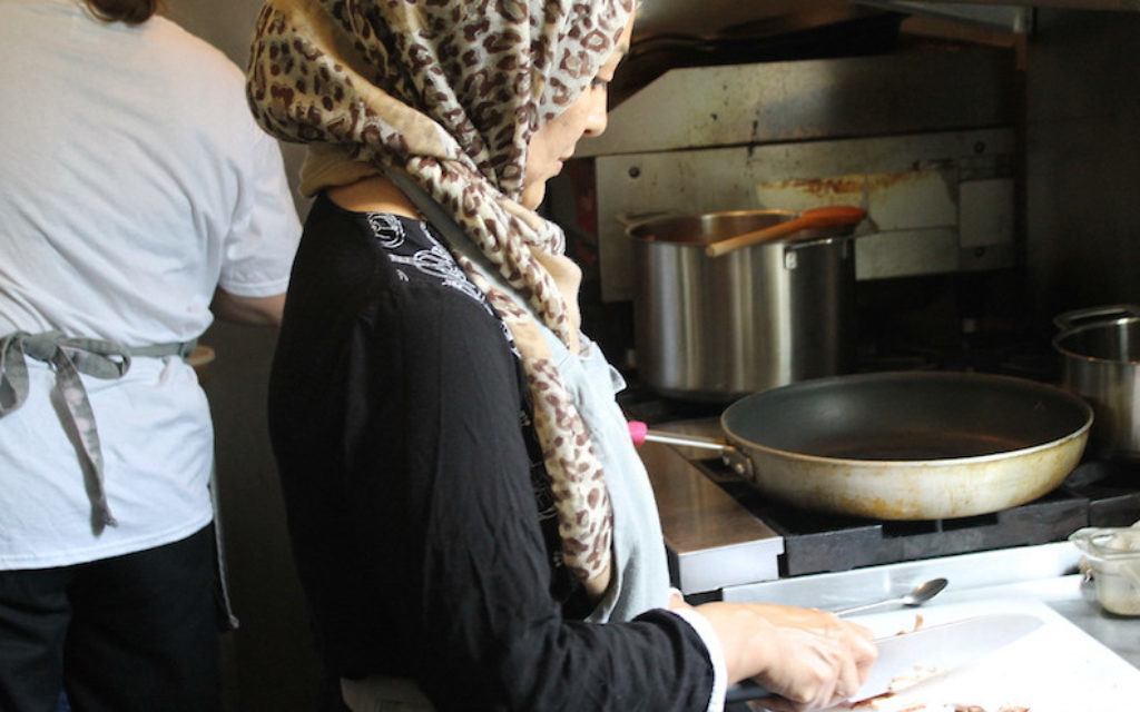 Naseema, a refugee from Afghanistan who did not give her last name, chops mushrooms for shakshuka, August 11, 2017. (Ben Sales/JTA) Naseema, a refugee from Afghanistan who did not give her last name, chops mushrooms for shakshuka, August 11, 2017. (Ben Sales/JTA)