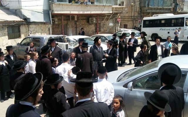 Ultra-Orthodox protesters against the army draft gather in the Mea Shearim neighborhood of Jerusalem as Defense Minister Avigdor Liberman paid a condolence visit to a family in mourning in the area, August 8, 2017. (Israel Police) Ultra-Orthodox protesters against the army draft gather in the Mea Shearim neighborhood of Jerusalem as Defense Minister Avigdor Liberman paid a condolence visit to a family in mourning in the area, August 8, 2017. (Israel Police)