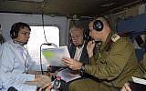 Israel's ambassador to the UN Danny Danon, left, with United Nation's Secretary-General Antonio Guterres, center, and IDF Deputy Chief of Staff Aviv Kohavi, in a helicopter as they review the security situation along Israel's border with the Gaza Strip, August 30, 2017. (Israel UN/Shlomi Amsalem)