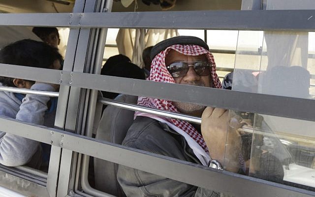 A member of the Islamic State (IS) group looks out of the window of a bus in Qara area in Syria's Qalamoun region on August 28, 2017 as IS members and their families they are transported to Deir Ezzor under part of an unprecedented deal to end three years of jihadist presence. (AFP / LOUAI BESHARA) A member of the Islamic State (IS) group looks out of the window of a bus in Qara area in Syria's Qalamoun region on August 28, 2017 as IS members and their families they are transported to Deir Ezzor under part of an unprecedented deal to end three years of jihadist presence. (AFP / LOUAI BESHARA)