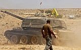 Illustrative image of a tank flying the Hezbollah terror group's flag seen in the Qara area in Syria's Qalamoun region on August 28, 2017 (AFP Photo/Louai Beshara)