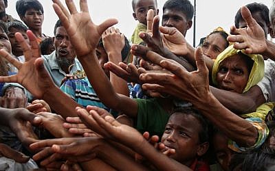 This August 30, 2017 photo shows Rohingya refugees reaching for food aid at Kutupalong refugee camp in Ukhiya near the Bangladesh-Myanmar border. (AFP PHOTO / STR)