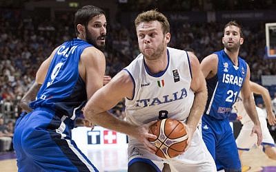 Illustrative: Italy's power forward Nicolo Melli (R) dribbles past Israel's small forward Omri Casspi (L) during the FIBA EuroBasket match between Italy and Israel at Menora Mivtachim Arena in Tel Aviv on August 31, 2017. (AFP Photo/Jack Guez)