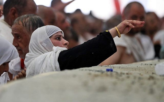 A female Muslim pilgrim partakes in the symbolic stoning of the devil at the Jamarat Bridge in Mina, near Mecca, which marks the final major rite of the hajj on September 1, 2017. (AFP / KARIM SAHIB) A female Muslim pilgrim partakes in the symbolic stoning of the devil at the Jamarat Bridge in Mina, near Mecca, which marks the final major rite of the hajj on September 1, 2017. (AFP / KARIM SAHIB)