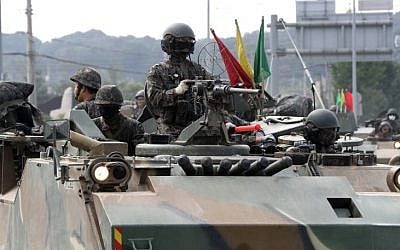 South Korean soldiers sit on the top of a military armored vehicle on the road in the border city of Paju on September 3, 2017. (AFP Photo/Donga Ilbo/STR)
