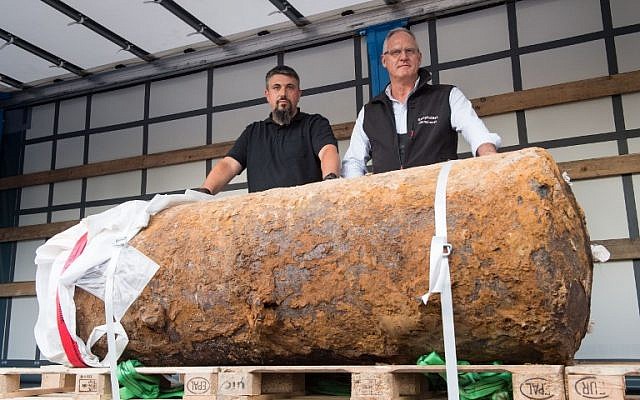 Illustrative: Dieter Schwetzler, right, and Rene Bennert of the Explosive Ordnance Disposal Division stand behind a World War II bomb they defused in Frankfurt, Germany, on September 3, 2017. (AFP PHOTO / Thomas Lohnes) Illustrative: Dieter Schwetzler, right, and Rene Bennert of the Explosive Ordnance Disposal Division stand behind a World War II bomb they defused in Frankfurt, Germany, on September 3, 2017. (AFP PHOTO / Thomas Lohnes)