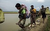 Displaced Rohingya refugees from Rakhine state in Myanmar walk near Ukhia, at the border between Bangladesh and Myanmar, as they flee violence on September 4, 2017. (AFP/K.M. Asad)