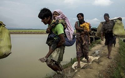Displaced Rohingya refugees from Rakhine state in Myanmar walk near Ukhia, at the border between Bangladesh and Myanmar, as they flee violence on September 4, 2017. (AFP/K.M. Asad)