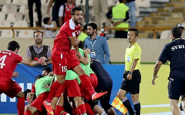 Syria's players celebrate at the end of their FIFA World Cup 2018 qualification football match against Iran at the Azadi Stadium in Tehran on September 5, 2017. (AFP PHOTO / ATTA KENARE) Syria's players celebrate at the end of their FIFA World Cup 2018 qualification football match against Iran at the Azadi Stadium in Tehran on September 5, 2017. (AFP PHOTO / ATTA KENARE)