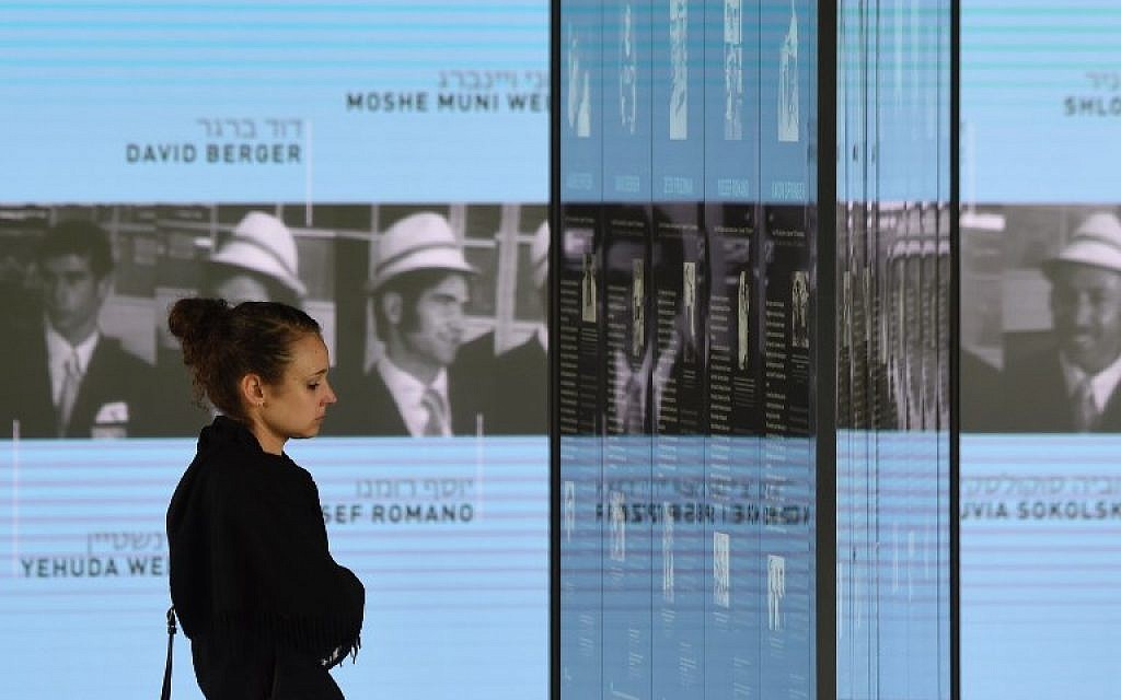 A visitor looks at the portraits of the Israeli athletes murdered at the 1972 Munich Olympics at the Olympic Village displayed inside the Memorial Center on September 6, 2017 in Munich, Germany. (AFP PHOTO / Christof STACHE)